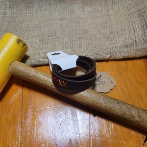 Brown leather bracelet with cross stitched design