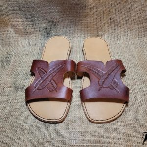 Hand made leather sandals with feathers tooled on the tops