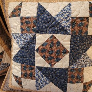 Quitled patchwork pillow in brown and blue